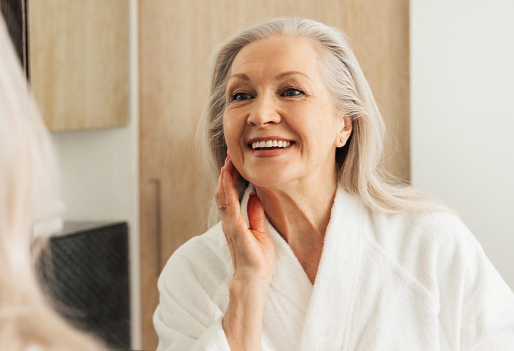 Lovely middle aged lady admiring her face.   Dr. Tanya Kormeili.  